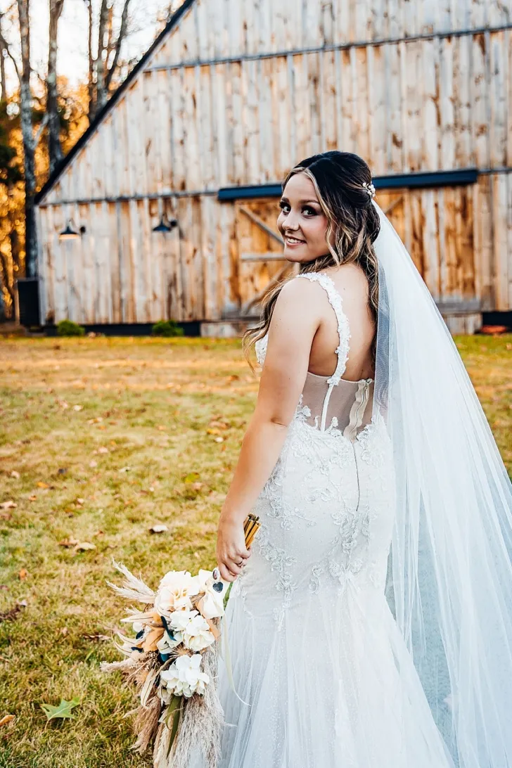 bride smiling at the camera and looking over her shoulder