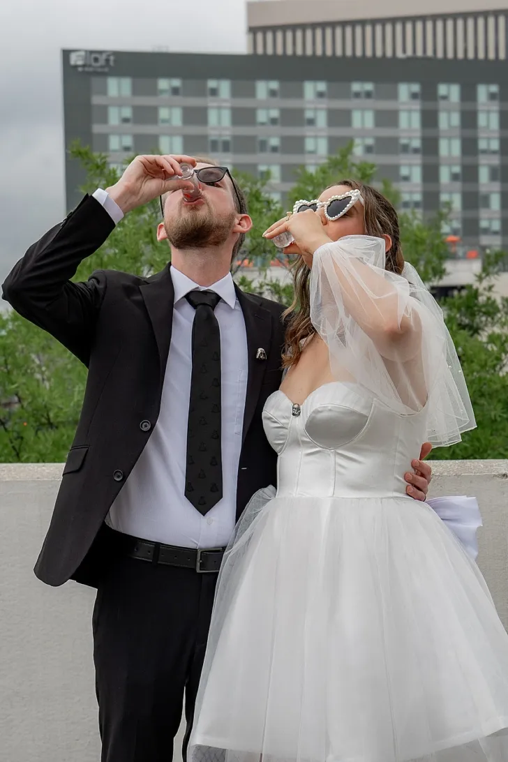 bride and groom taking a shot after wedding ceremony
