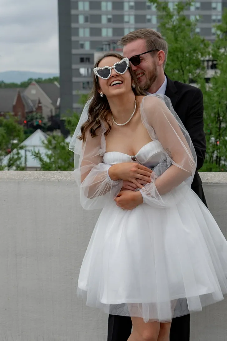 groom holding bride from behind