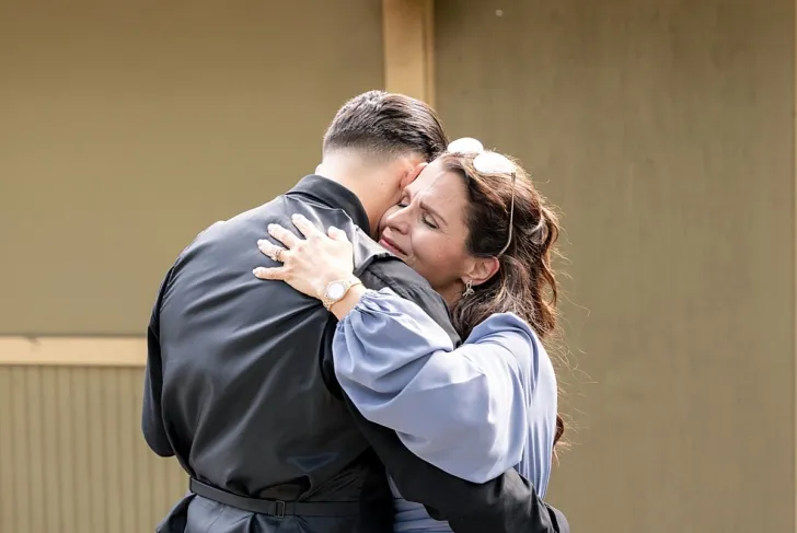 groom and mother of the groom hugging
