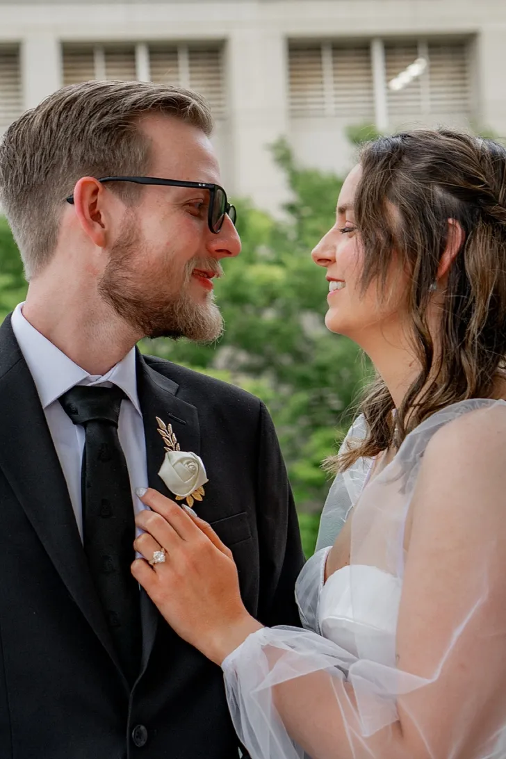 bride and groom smiling at each other
