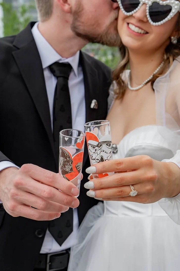 bride and groom doing a cheers after the wedding ceremony