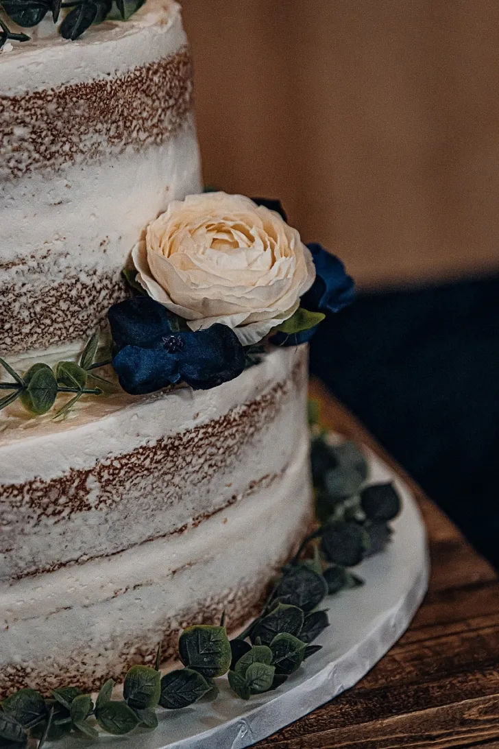 closeup of white wedding cake with florals