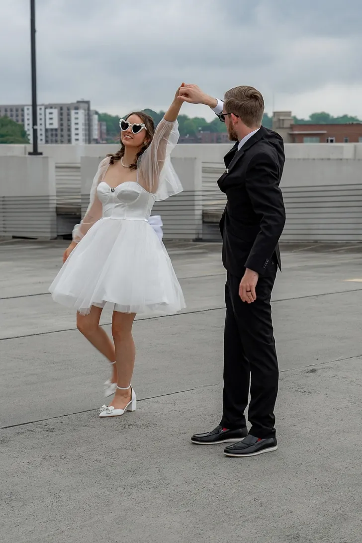 bride and groom dancing in the city hall parking lot