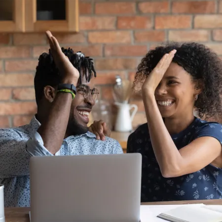 how marriage can affect your credit score - young couple celebrating good credit